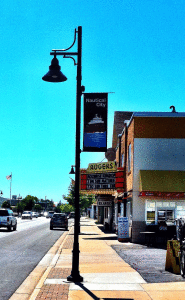 Black light pole with a banner in front of a movie theater.